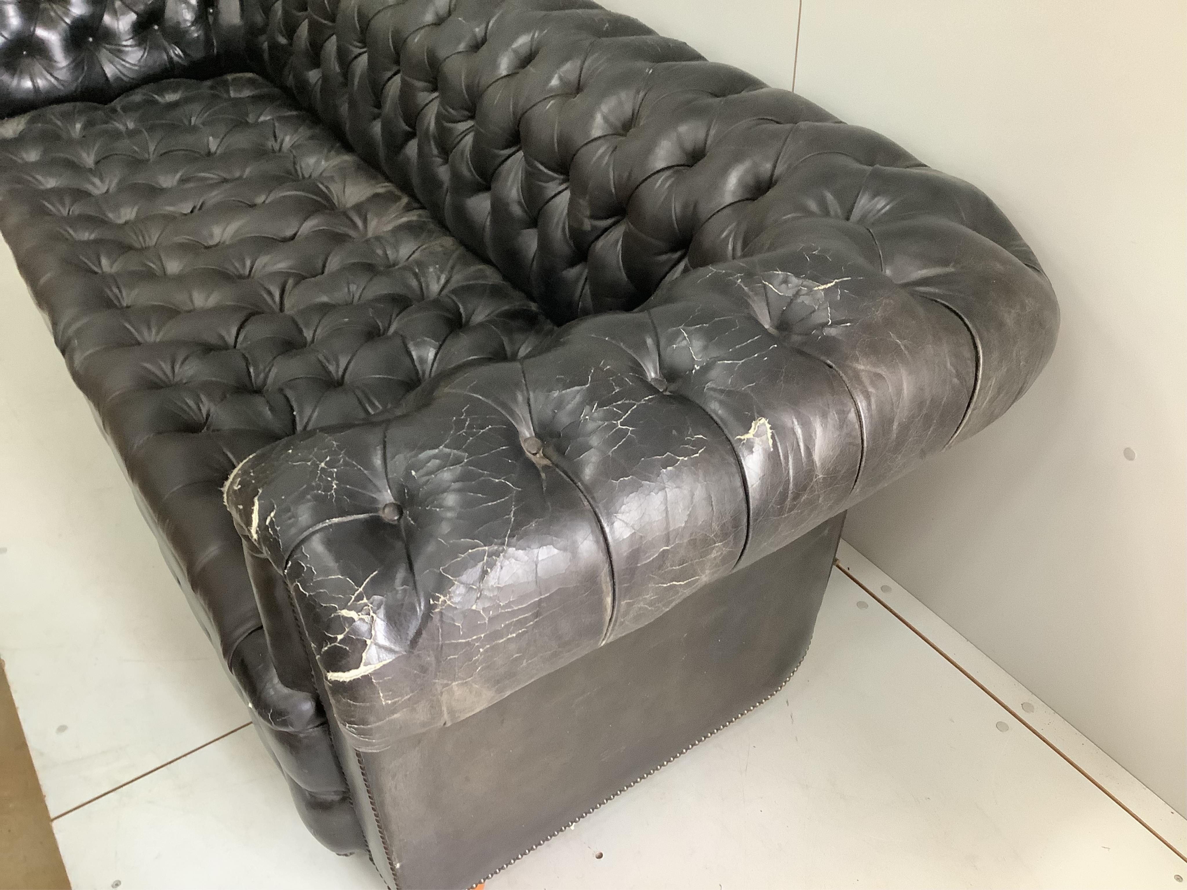 A Victorian style black leather button back chesterfield settee, width 230cm, depth 90cm, height 73cm. Condition - poor